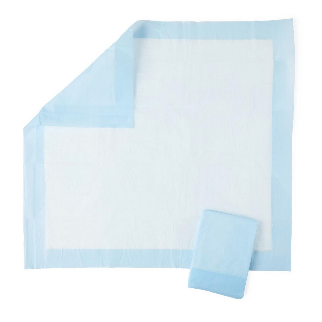 A Medline Protection Plus Disposable Underpad with a light blue border is laid flat, one corner folded to show its layers and polypropylene backing for moisture protection. Another underpad is folded and placed nearby.